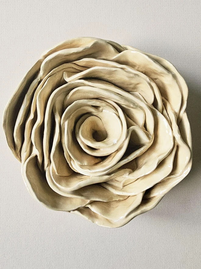 Cream handmade ceramic rose sculpture with a glossy glaze, crafted in 3D and designed to hang on a wall