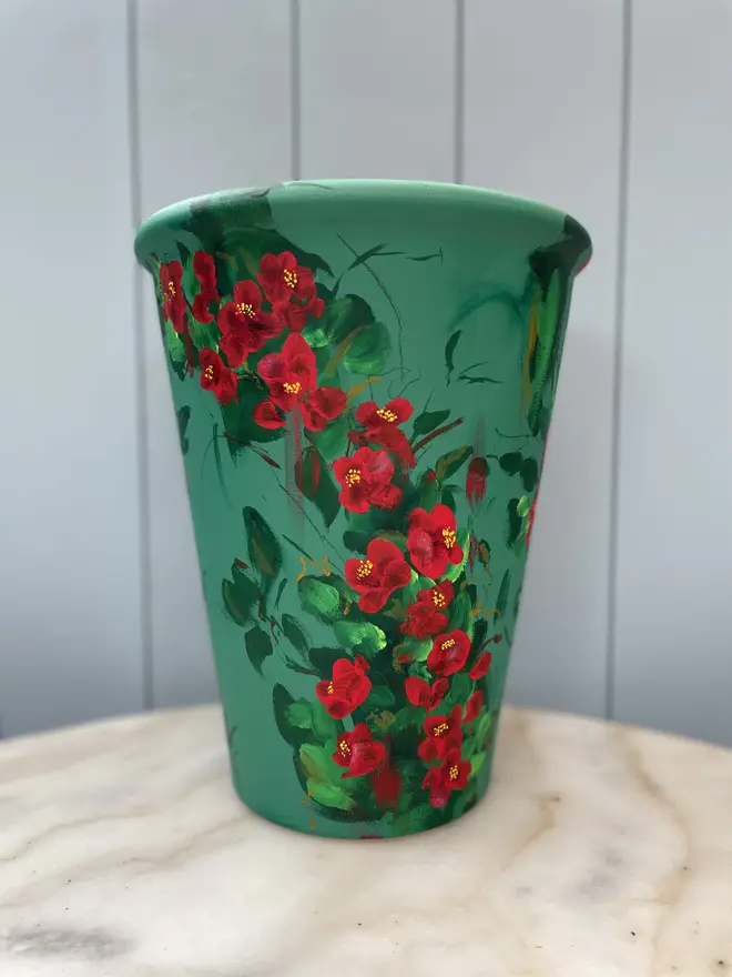 Unique hand-painted terracotta pot featuring quince on a deep rich green background
