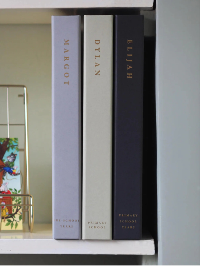 personalised wedding keepsake ring binder. personalised ring binders on a shelf to show spines.