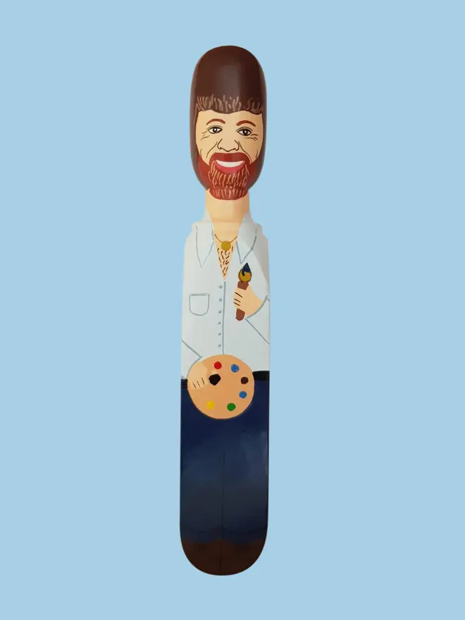 Wooden Door Stopper (Bobb), a colourful wooden door stop sitting on a white surface. 