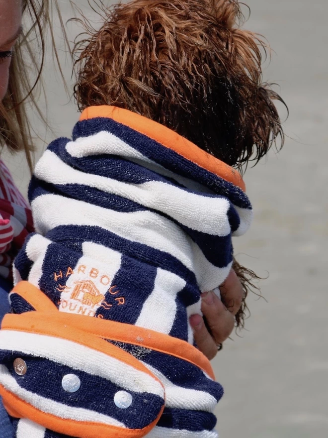 Nautically styled navy dog drying robe. 100% absorbent cotton. Popper fastening, tail hole and full belly coverage.  