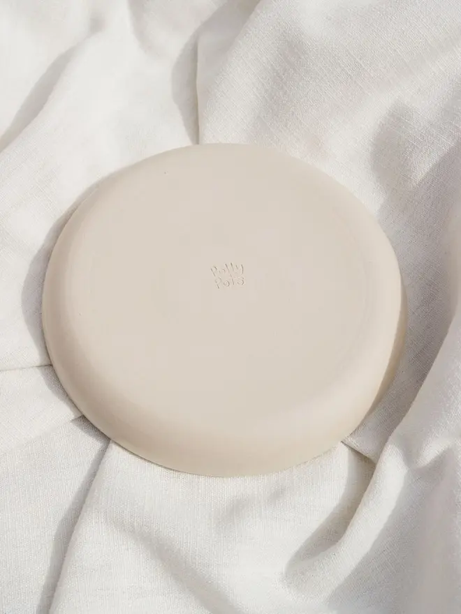 Snack Chicken Nuggets & Dip Plate, a white snack dish sitting on a white bed cloth. It is covered in blue outlines for chicken nuggets. 