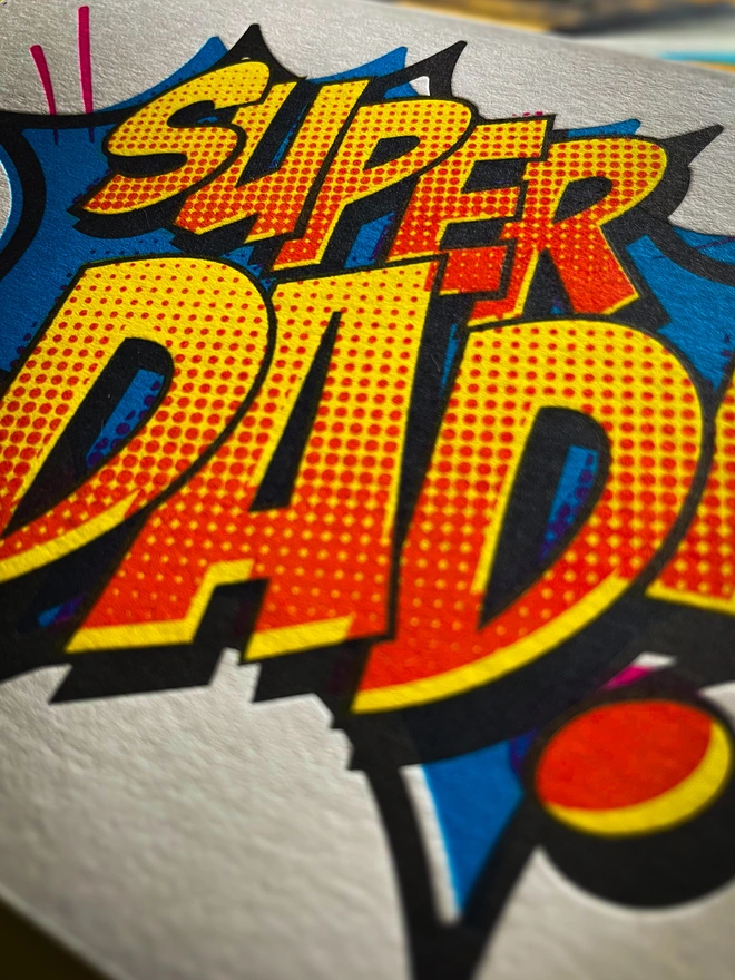 Detail of Pop Art Fathers day typographic letterpress card with fluorescent ink made by hand. Deep impression print. Unique with no print being the same. Vibrant colours with matching premium envelopes. With luxurious contrasting coloured envelopes.