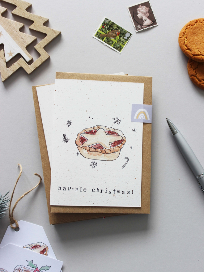 'Hap-Pie mince pie Christmas' Card on table with Christmas decorations