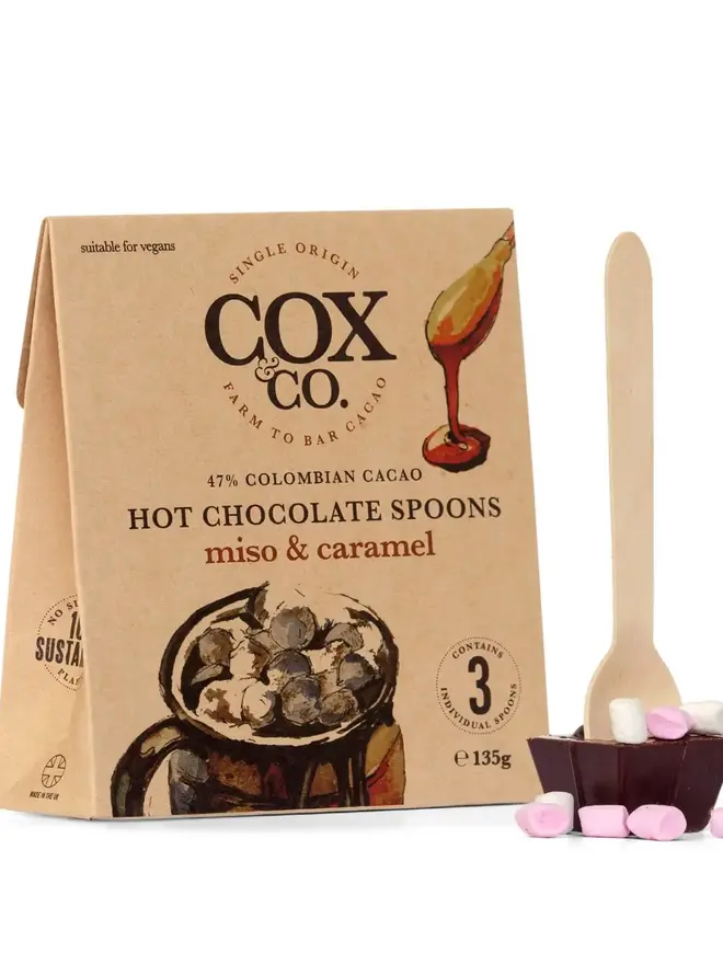 Cox&Co Hot Chocolate Spoons Miso & Caramel (Set Of 3), a chocolate spoon sitting next to its packaging on a white surface. 