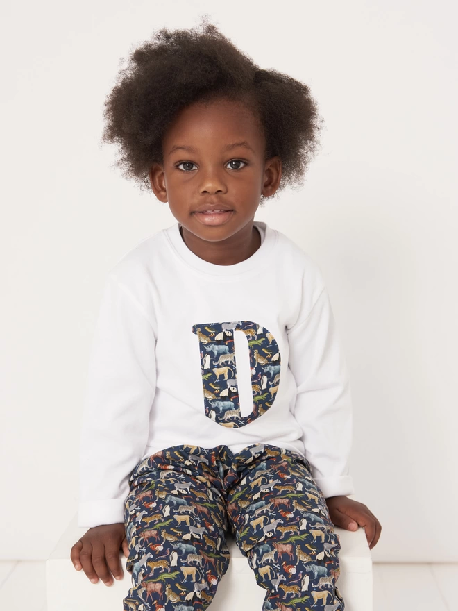 Kid wearing Initial white t-shirt in Quey 2 Liberty Print 
