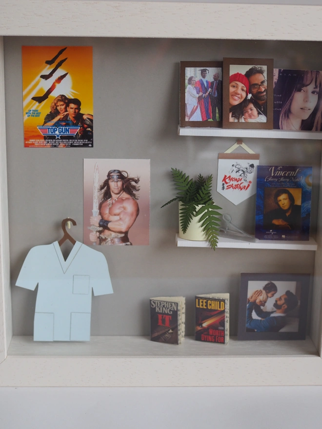 a wooden box with miniatures of the person favourite things inside. Each piece is handmade specially on request. bespoke art piece made by My Papercut Forest