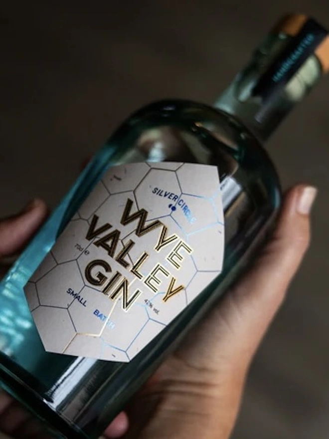  Wye Valley Gin, bottle of spirit held by a hand. 