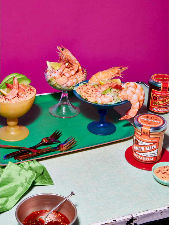 korean kimchi mayo. an assortment of prawn and seafood dishes, photographed alongside a jar of kimchi mayonnaise.