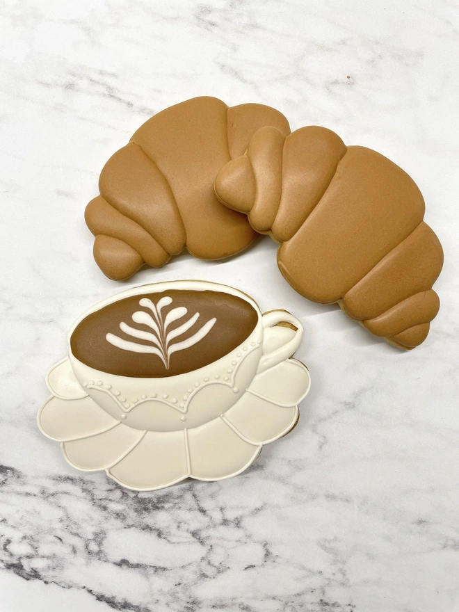 Hand-piped latte art coffee biscuit and croissant iced biscuit in elegant Milstone gift box.