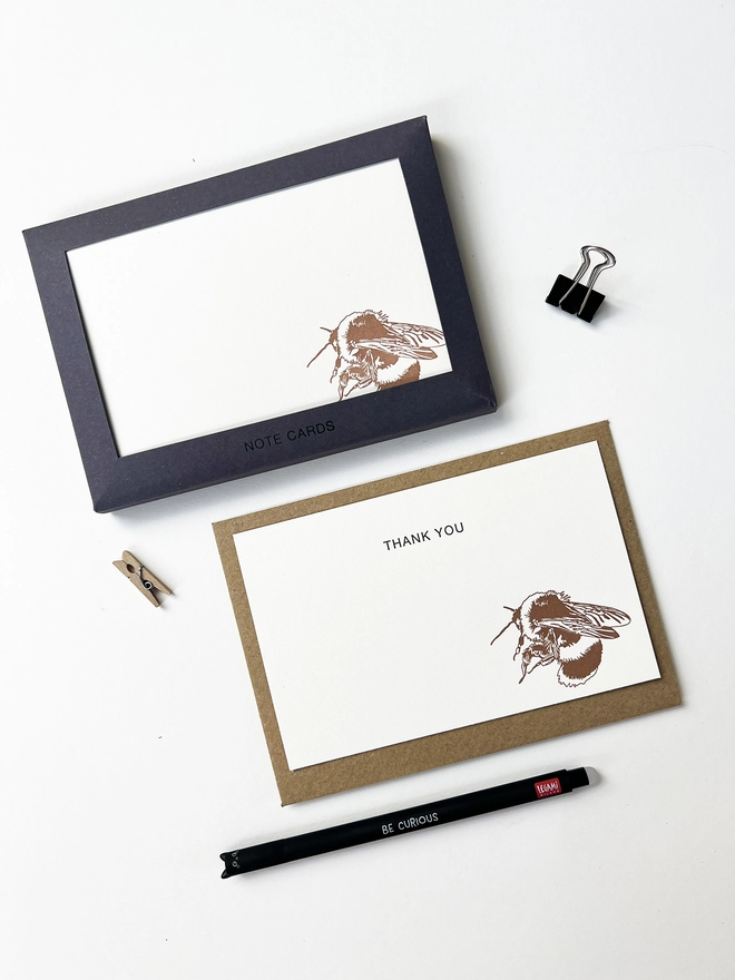 Boxed flat correspondence cards illustrated with a bumble bee