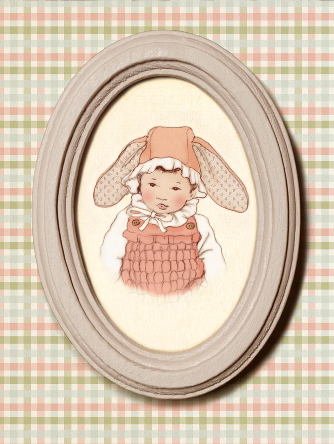 a sweet photograph of a asian chinese japanese baby in an easter bonnet drawn in a vintage childrens book style. framed in a dusty pink wooden frame