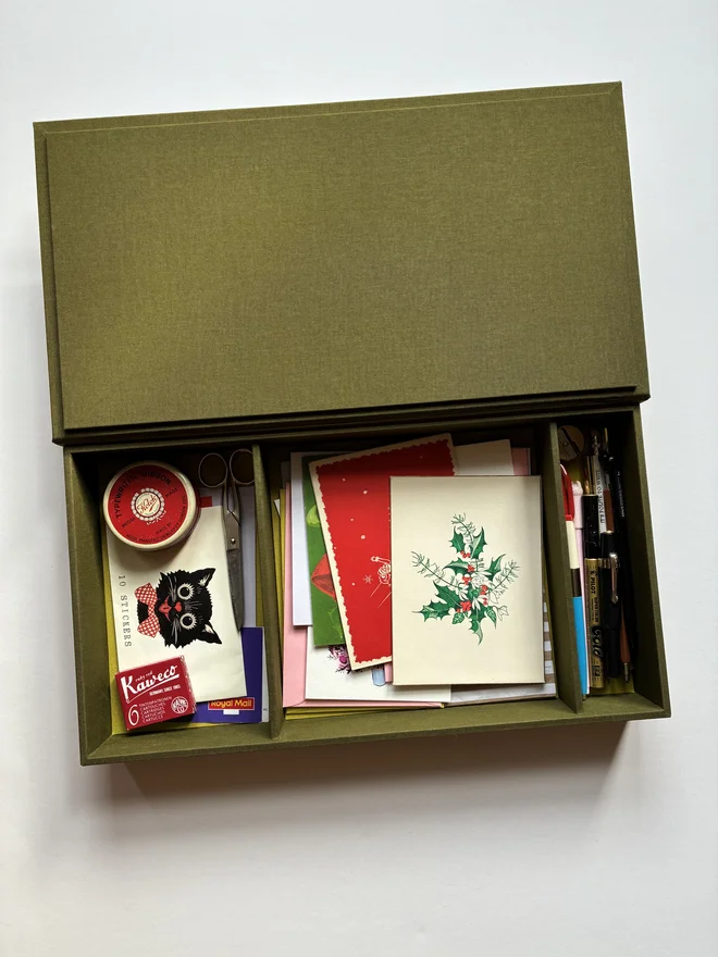Open handmade Christmas Correspondence box in Olive green cloth displaying cards and stationery items