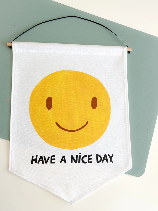 Have a nice day smiley banner on a white background on a table