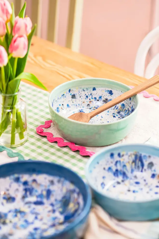 Shoreline Serving Bowls (Set Of 3), a colourful set of serving bowls placed in a table setting accompanied by other kitchen items. 