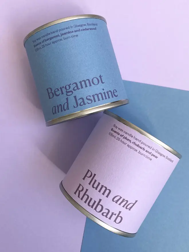 Bergamot & Jasmine Soy Wax Candle Tin against a purple and blue background. 