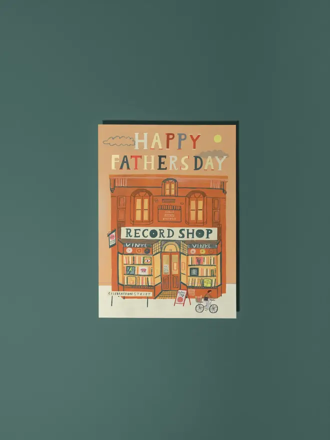 record shop illustrated fathers day card. illustrated red brick record shop building with 'happy fathers day' on orange background.