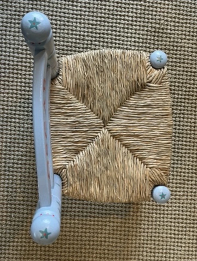 Wooden rush seat on a wooden chair for a child. 