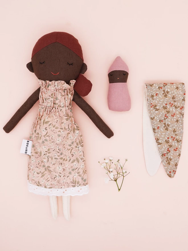 mother and baby fabric dolls with dark black skin and pink floral dress