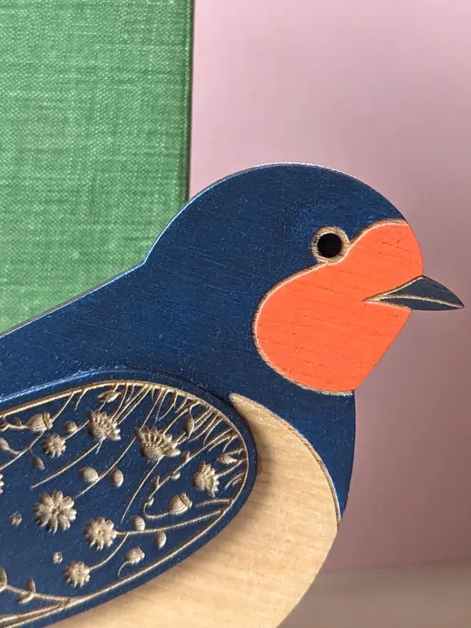 Standing Wooden Barn Swallow, blue wooden bird decoration standing on book. 