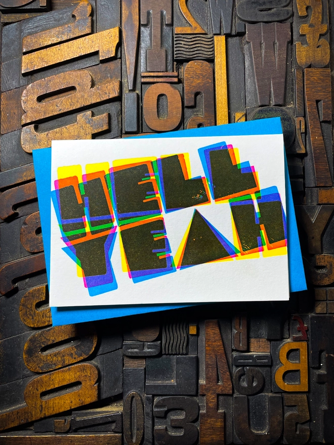 A congratulatory letterpress card using vibrant fluorescent inks the deep impression word HELL YEAH; in bold letters with a set of colourful envelopes. Perfect for exam results and graduations and other celebrations and milestones.