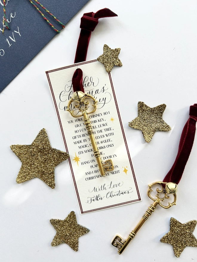 Golden Father Christmas Key attached to poem card and adorned with red velvet ribbon and small golden bell