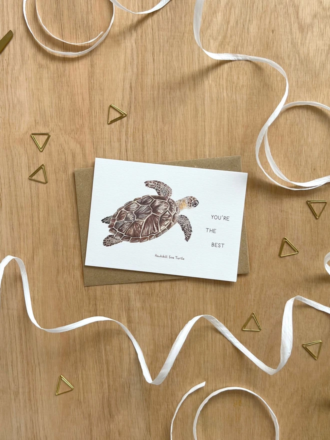 a greetings card featuring an illustration of a sea turtle with the text “You’re The Best”