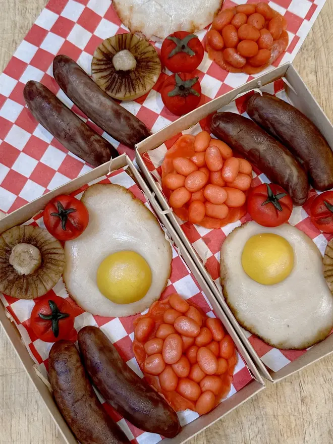 Brekkielicious Marzipan Box, sweet marzipan box displayed on a table surface. In the image are marzipan eggs, beans, mushrooms, tomatoes and sausages along with traditional red and white patterned cloth. 