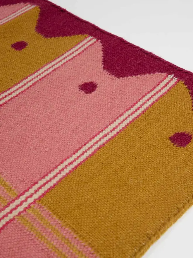 Ladder Flatweave Runner Rug, a colourful rug sitting on a white surface. 
