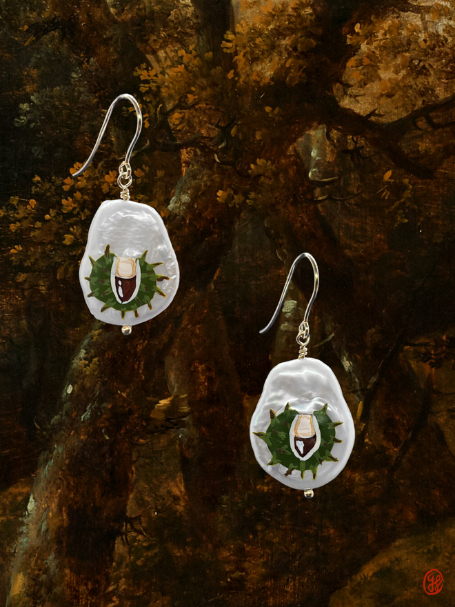 A pair of flat pear shaped pearl earrings each hand painted with a conker in the shell motif, all set in 9ct gold.