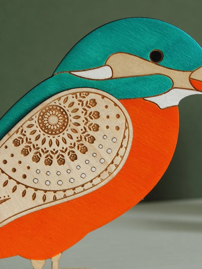 Standing Wooden Kingfisher, orange and blue wooden bird decoration standing on a platform. 
