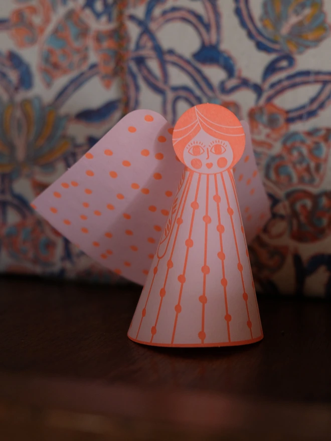 Angel Pop-out angel – orange ink on candy pink. 