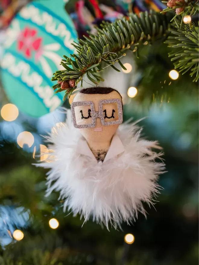 Elton John hanging Christmas decoration
