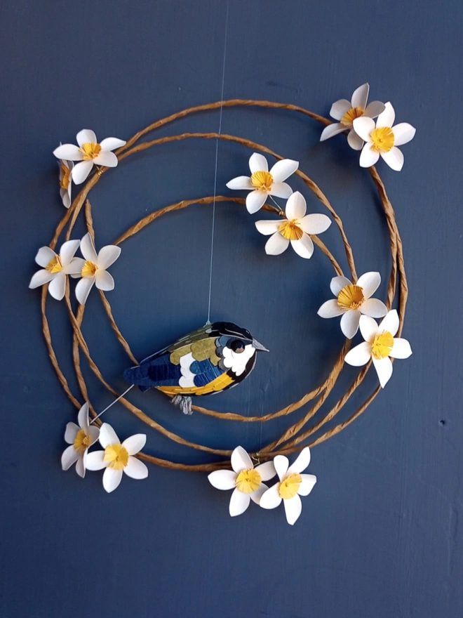 Great tit paper sculpture on a wreath of blossom flowers