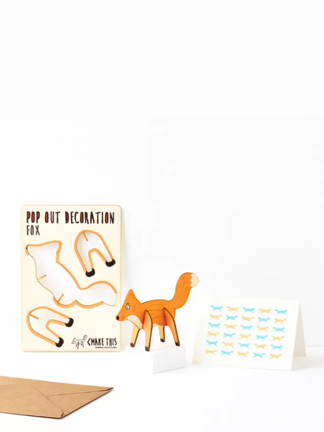 Ginger fox decoration and fox pattern greeting card and brown kraft envelope on a white background