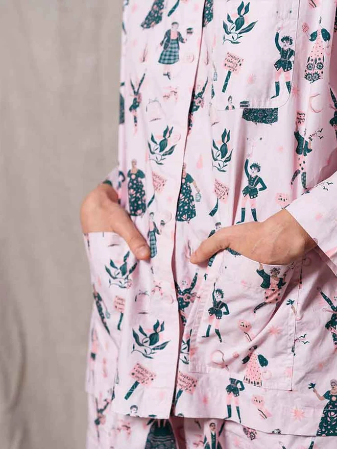 A close up of our pale pink pyjamas highlighting the two front pockets of the top and the icon print