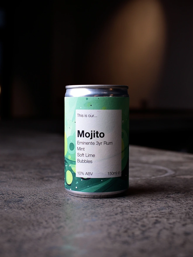 Mojito can shot on concrete against a dark background