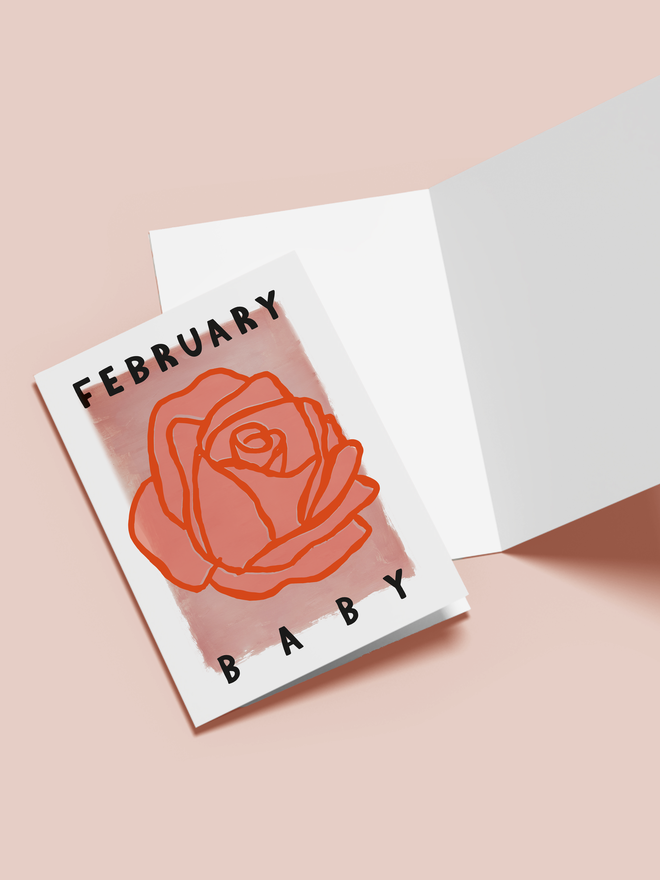 'february baby' illustrated card. a pink card with an illustrated rose in the centre.