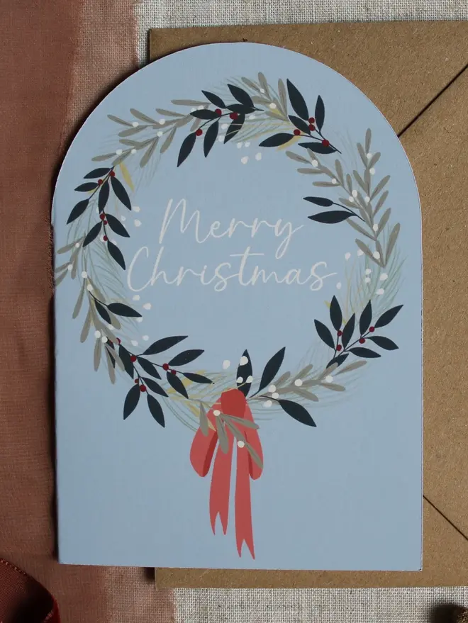 illustrated christmas wreath card. arch shaped christmas card illustrated with a wreath.