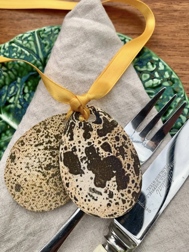 speckled egg place setting with gold ribbon