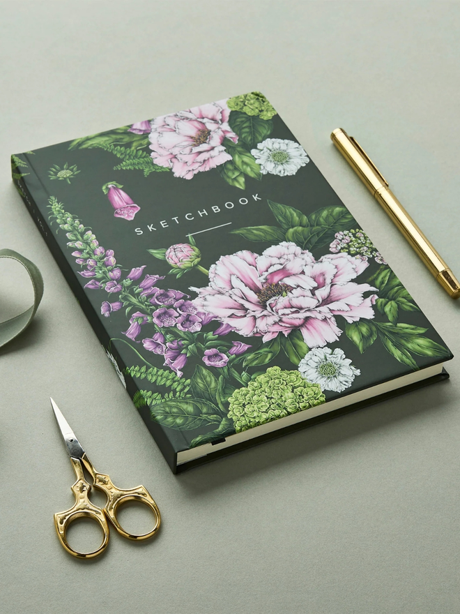 'Summer Garden' A5 Hardback Sketchbook. a green floral sketchbook photographed on a plain grey background.