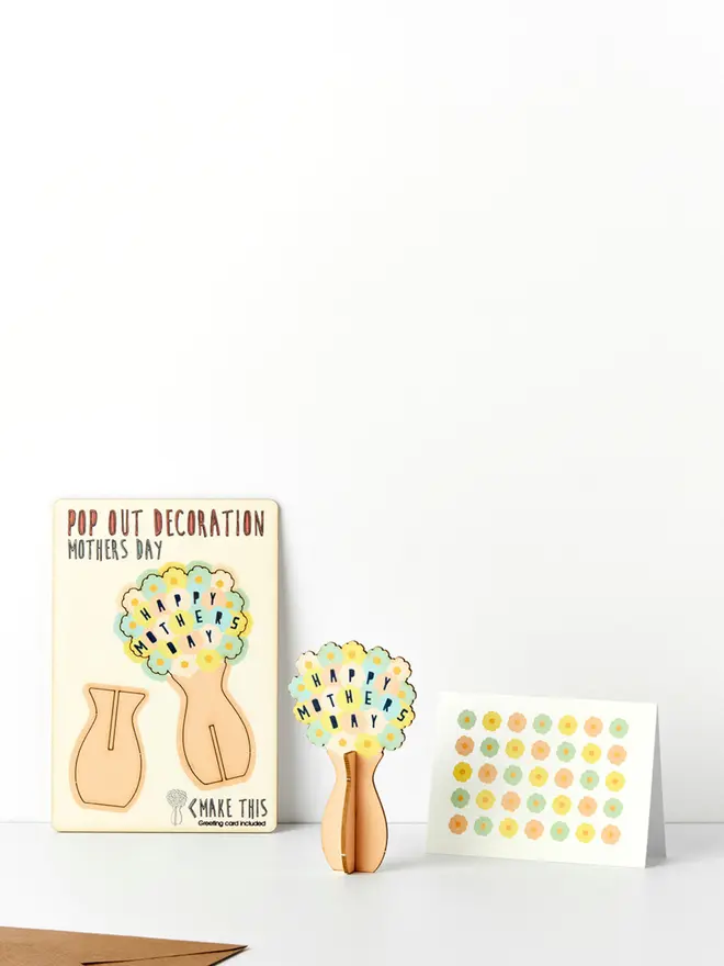 Mother's Day laser cut decoration and flower pattern Mother's Day card and brown kraft envelope on a white background