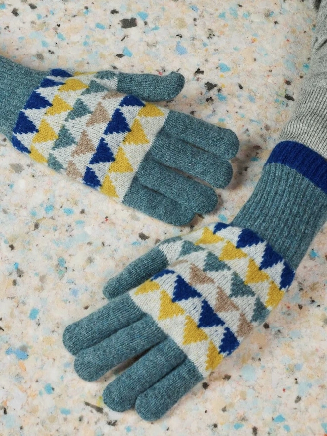 Women's Lambswool Gloves, a woman wearing a pair of colourful gloves outdoors. 
