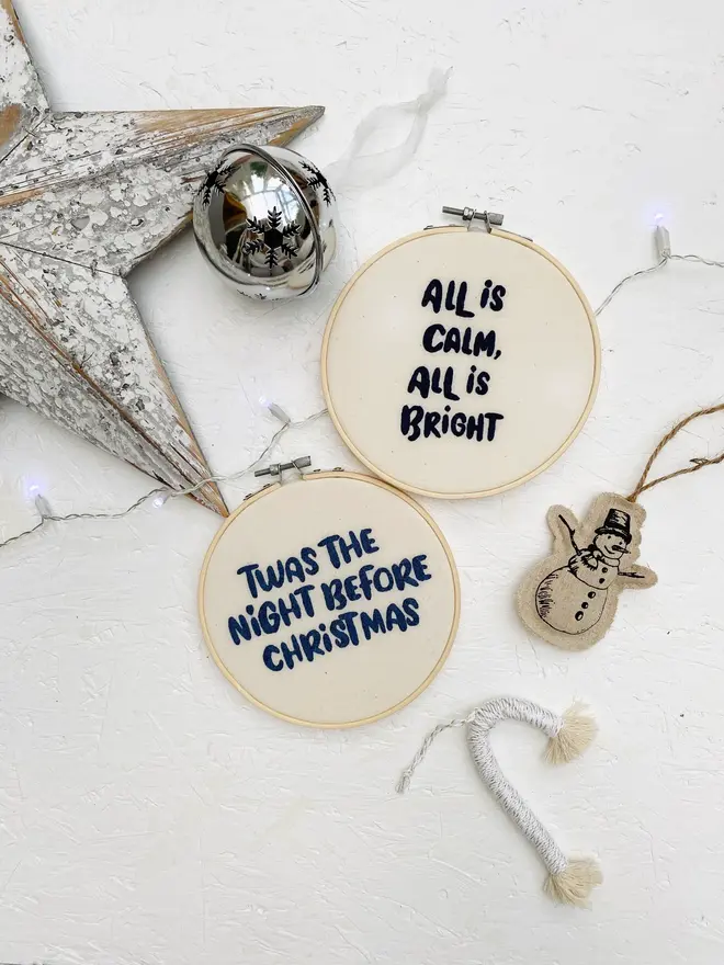 custom phrase embroidered christmas hoop. cotton hoop embroidered with assorted festive phrases.