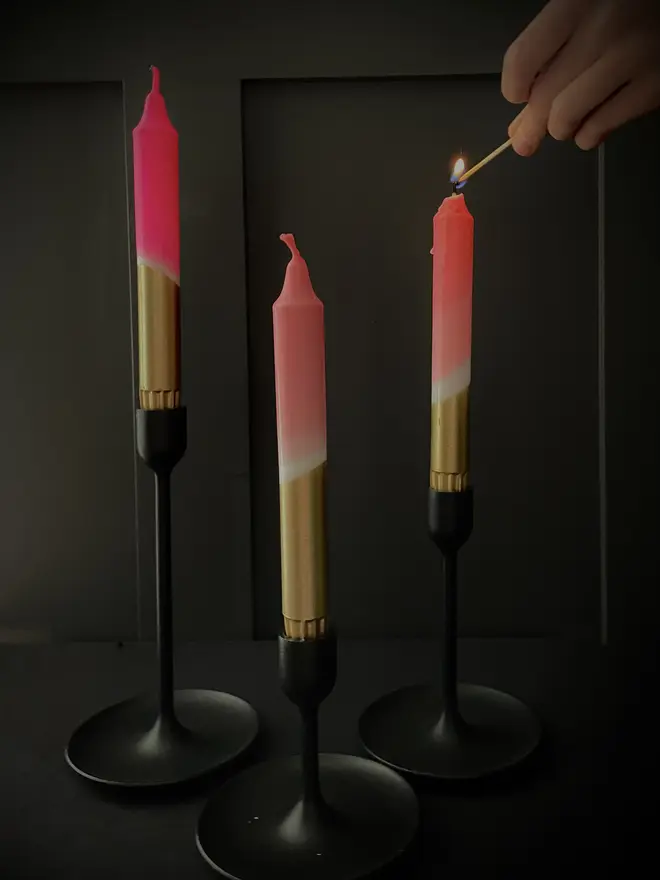 lighting 3 pink and gold candles