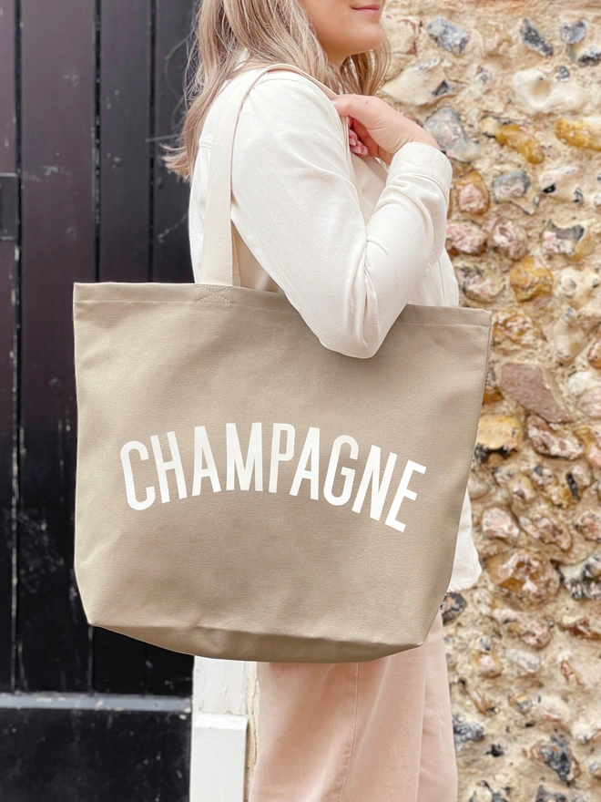 'Champagne' Tote Bag being worn over the shoulder