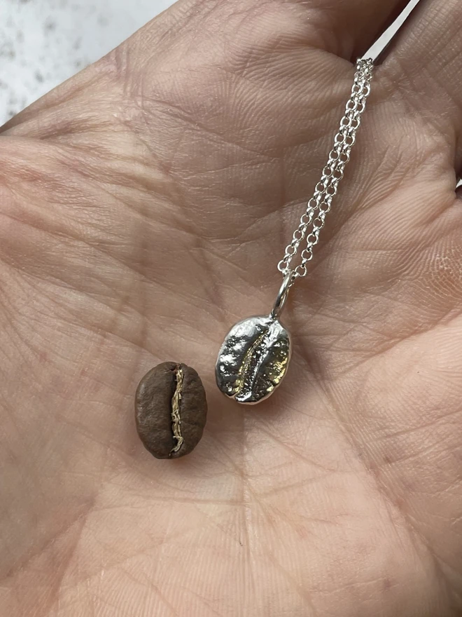 'But First, Coffee' necklace. This brew-tiful little charm pendant is a necessity for the coffee obsessed. This necklace is a tribute to your undying love for the magical elixir of life. The pendant has been sandcast from a real coffee bean using recycled sterling silver. Handmade in my small little studio in Salisbury. 