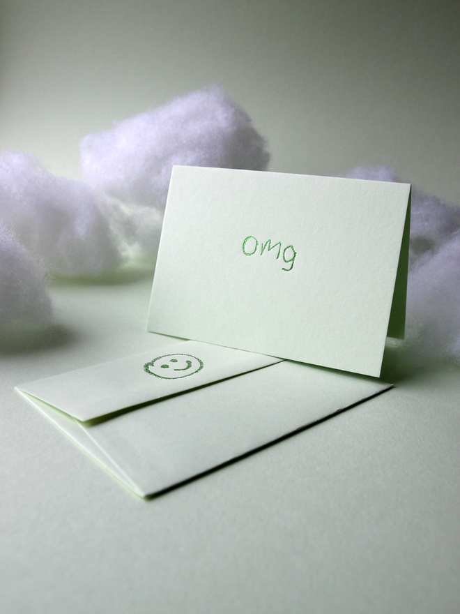 pistachio coloured card with omg short for 'oh my god' hand foiled in kids hand writing