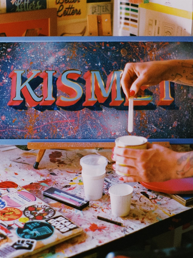 Kismet piece with paint pots in front.
