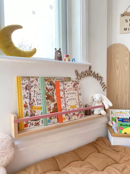 Our large handmade bookshelf in a cosy children's play corner, decorated with books, teddies, wooden signs and soft furnishings 
